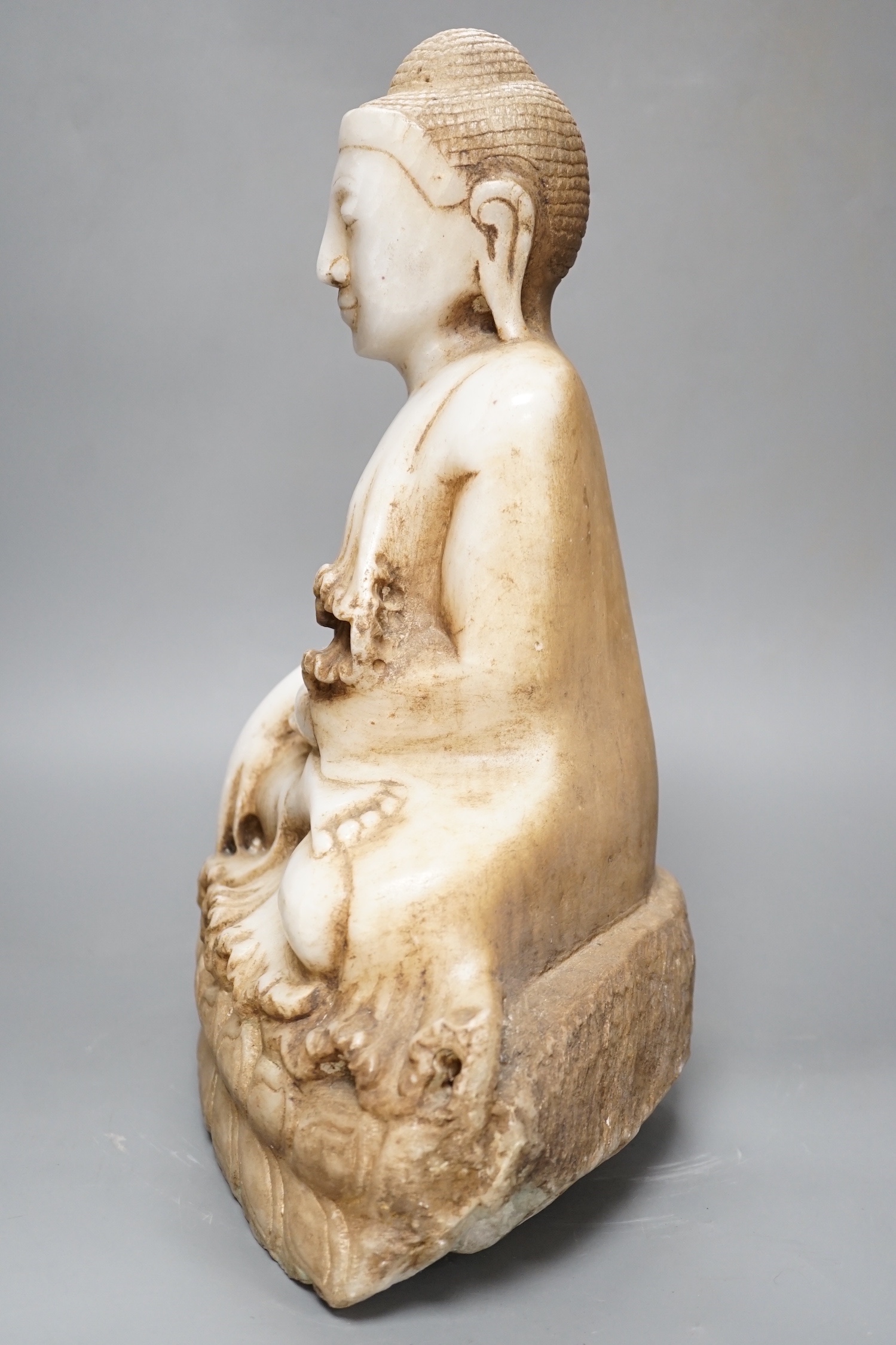 A Burmese carved marble seated Buddha on lotus throne, 20th century - 39cm high